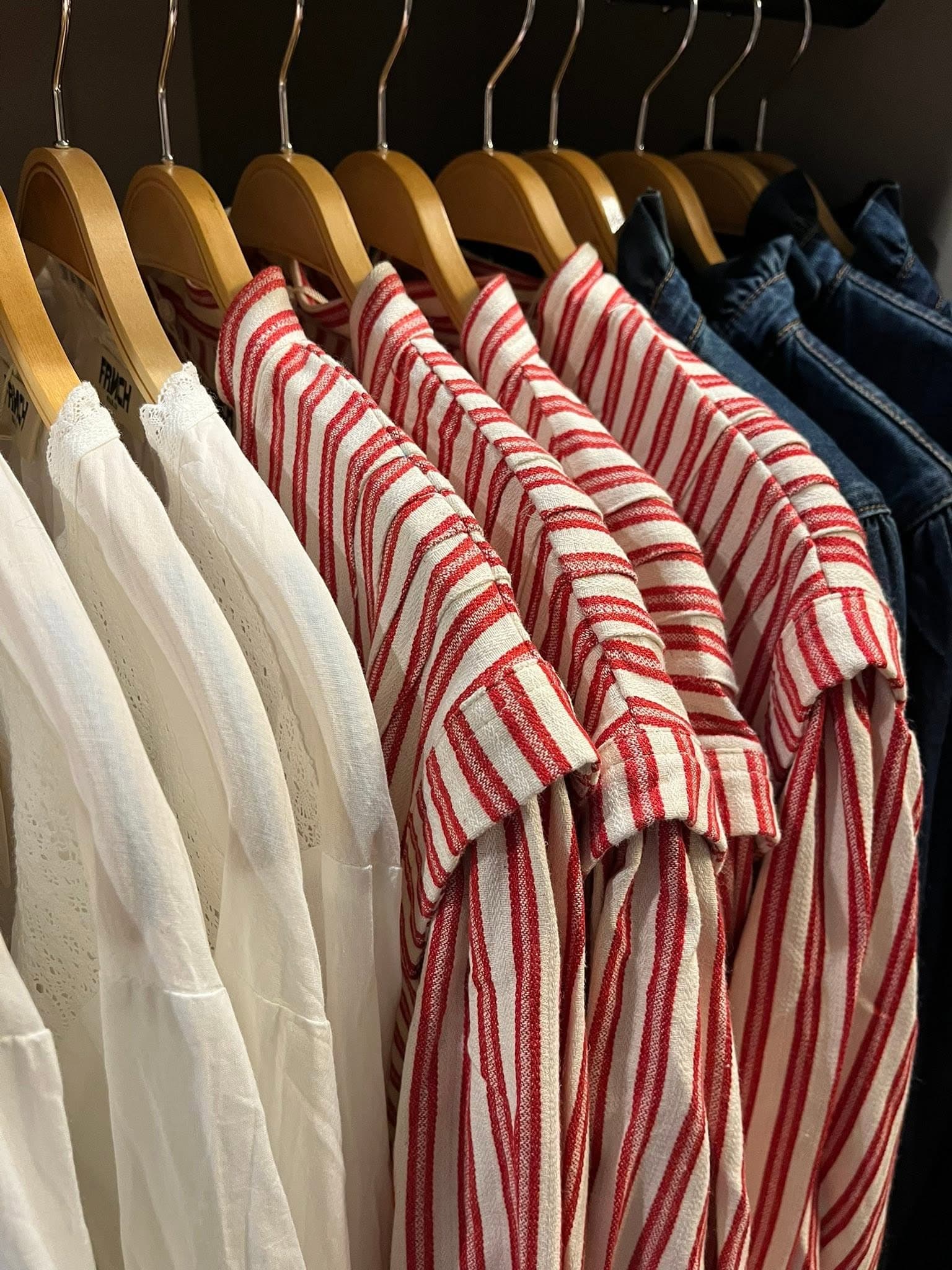 Striped and neutral clothes hanging in store